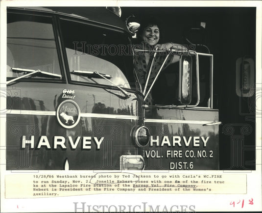 1986 Press Photo Jonelle Hebert poses with fire truck of Harvey Volunteer Fire - Historic Images