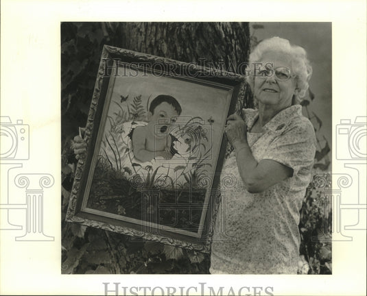 1988 Press Photo Hermanie Hebert, holding one of her recent paintings. - Historic Images