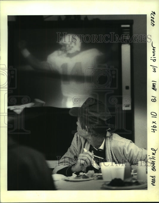 1992 Press Photo Unidentified, savors meal- Bridge House while watching football - Historic Images