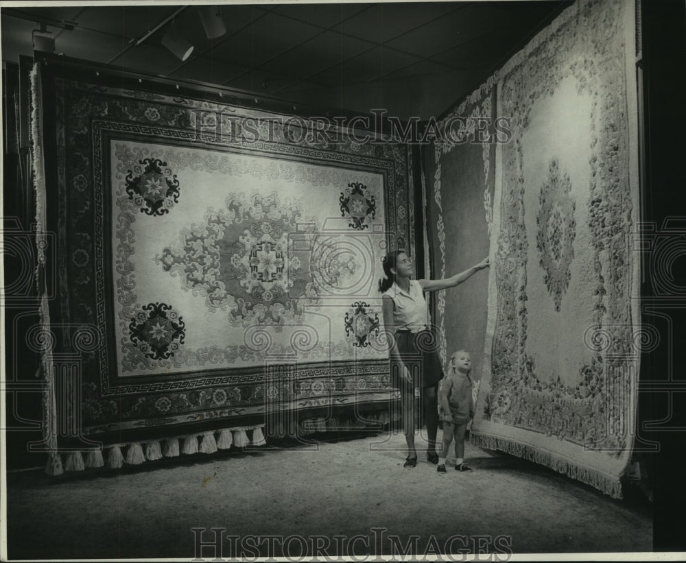 1973 Press Photo Customer looking at carpets on display. - nob35113 - Historic Images