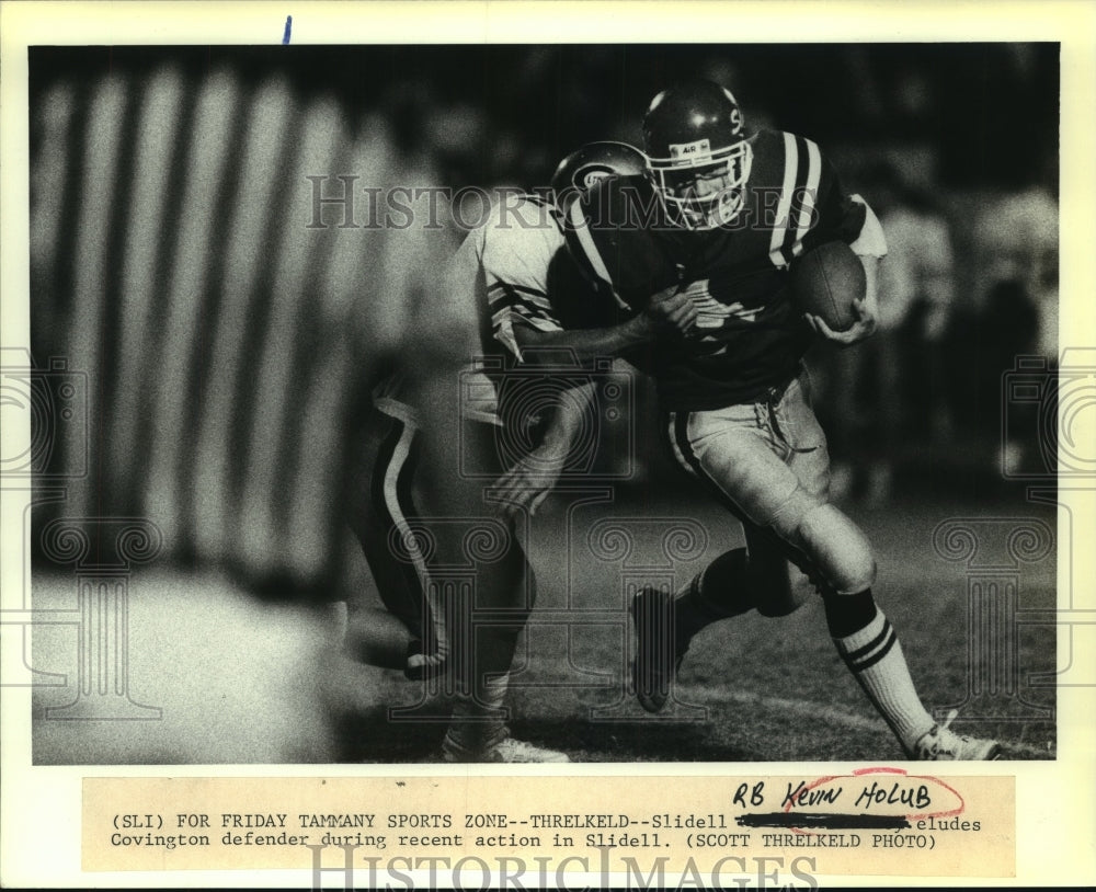 1992 Press Photo Slidell Running Back Kevin Holub eludes Covington defender - Historic Images