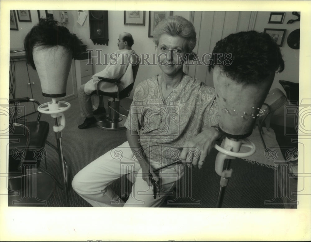 1990 Dani Honold with couple of hair pieces in her shop on Burgundy - Historic Images