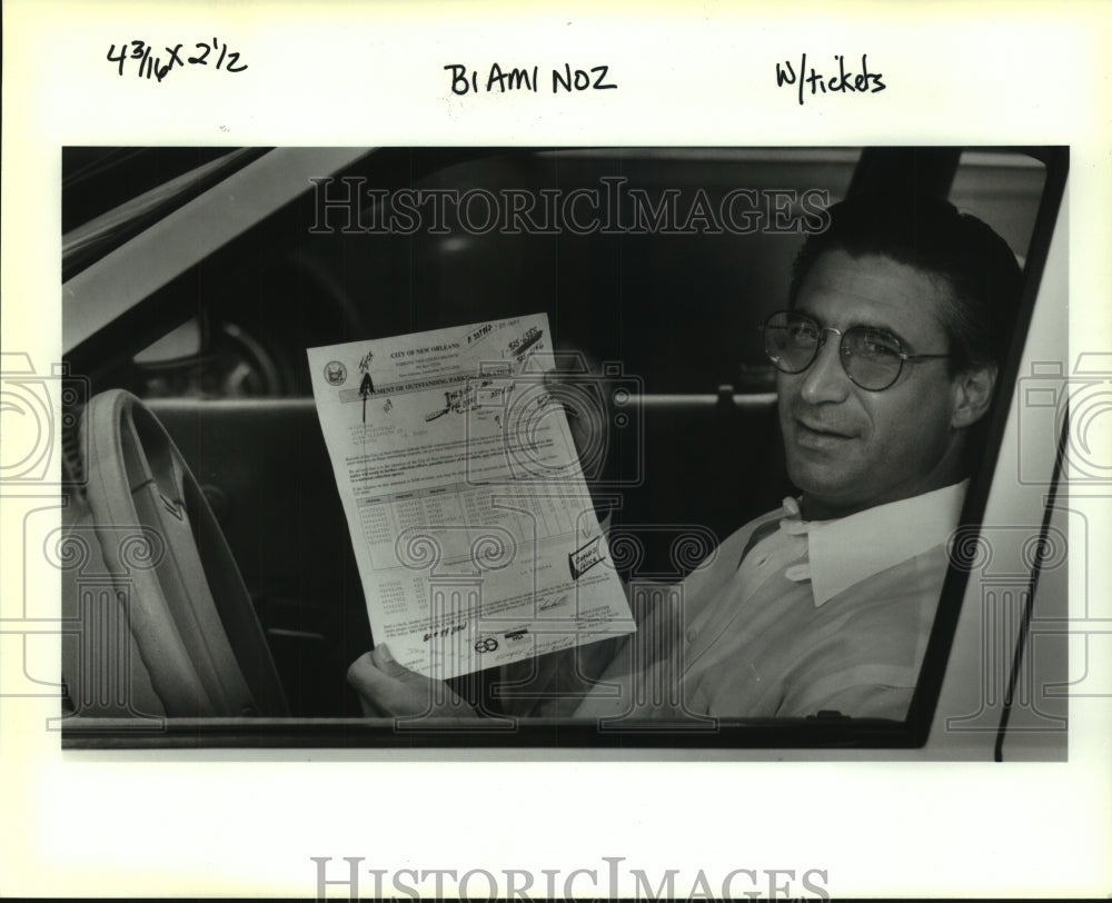 1992 Press Photo Jay Hondroulis with tickets mistakenly charged to his car - Historic Images