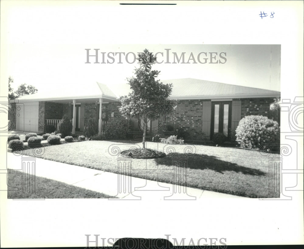 1990 A home with a small shade tree growing out front in Chalmette - Historic Images