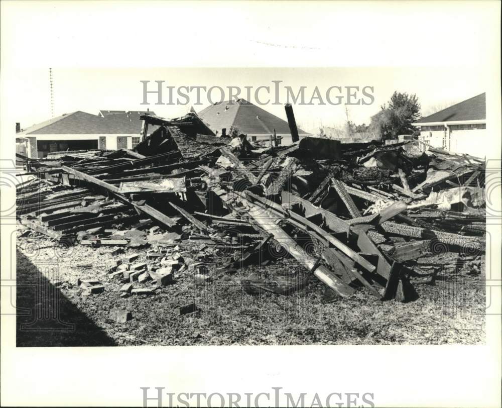 1985 Charred pile of wood and bricks remains of the vacant house - Historic Images