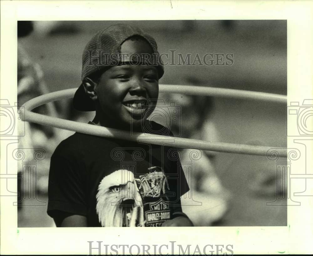 1988 Bridgedale Student Alfred Francis puts hula hoop around neck - Historic Images