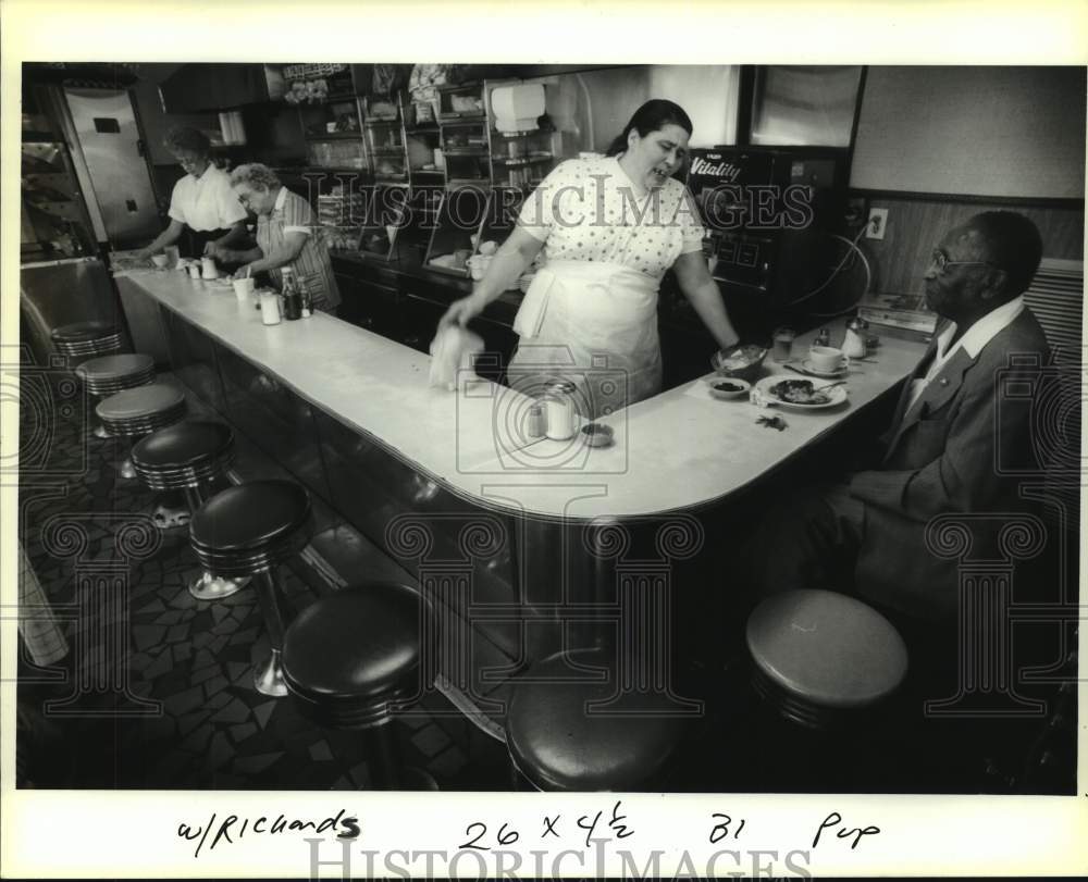 1990 Suzanne Hughes talks to one of her regulars at lunch counter - Historic Images