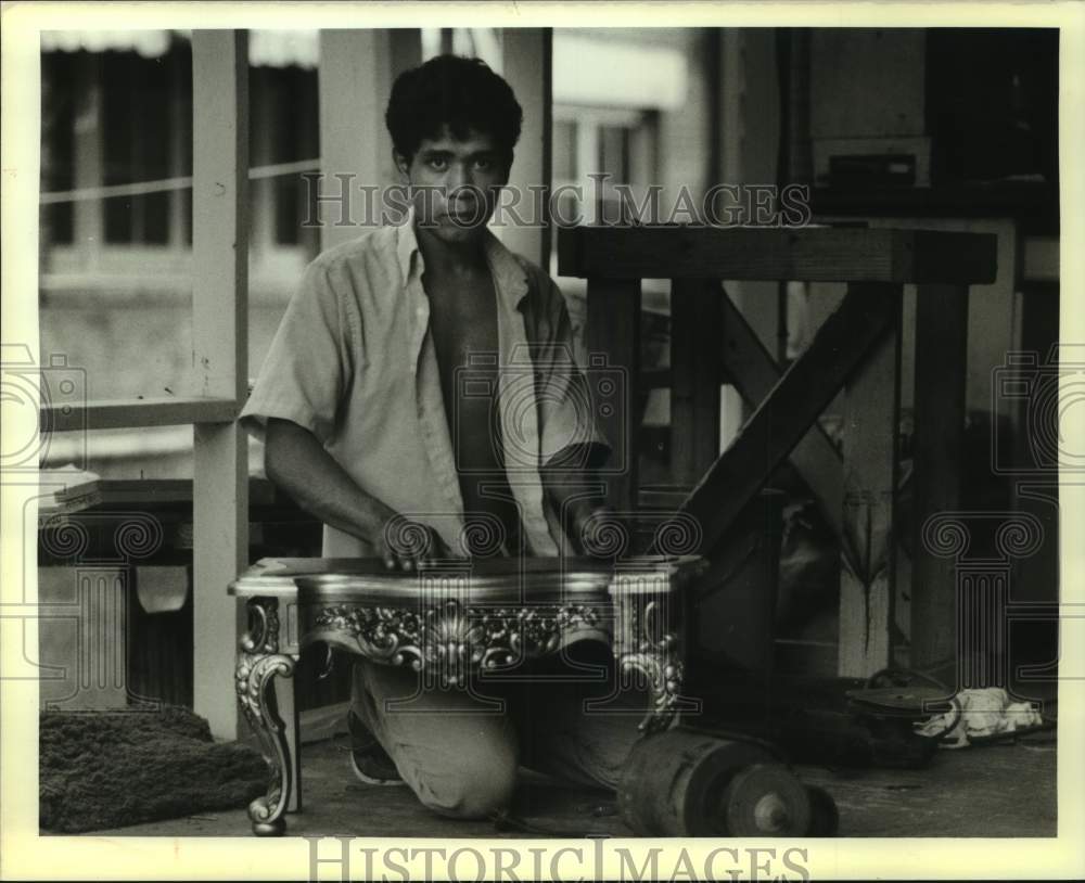 1988 Jose Palacios repairing a table at Casa Nicolas shelter - Historic Images