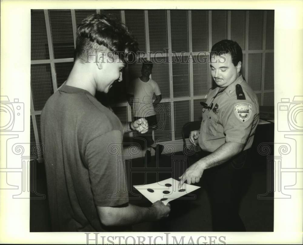 1994 Press Photo Craig Vucinovich gets target checked at Firearm Safety Course. - Historic Images