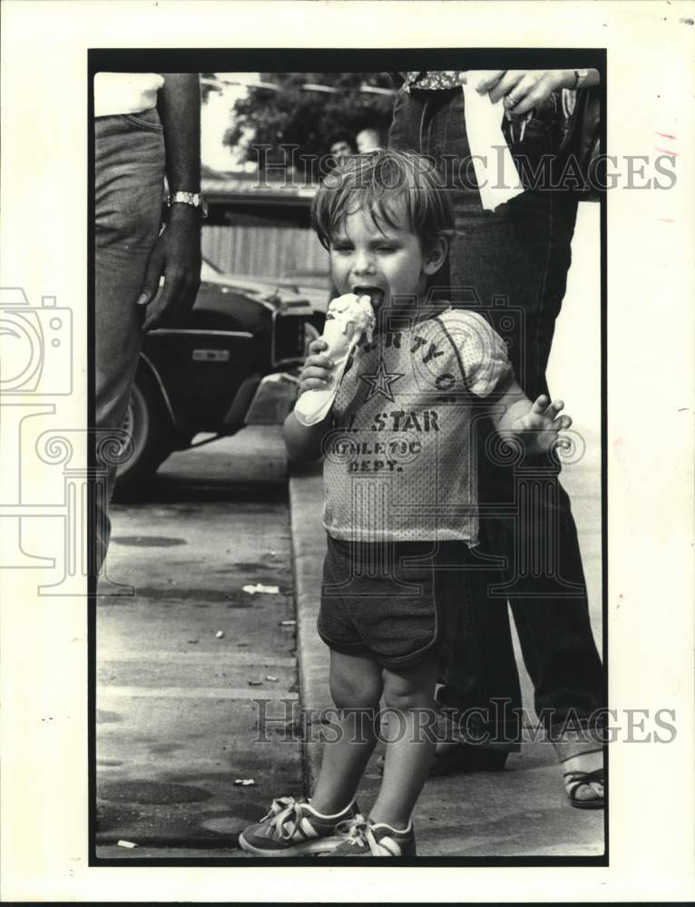 Press Photo A toddler eating a give away Ice Cream - Historic Images