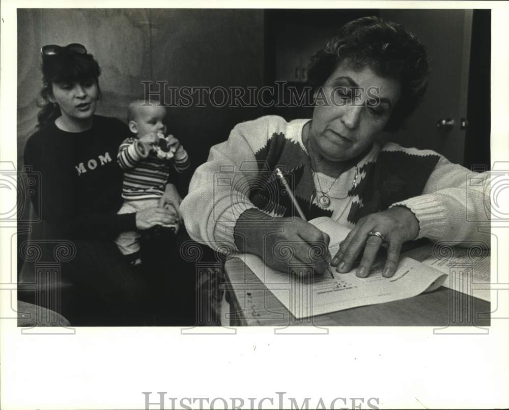 1988 Press Photo Tamanika Odinga of Interagency Center weighs Rennis Douglas - Historic Images