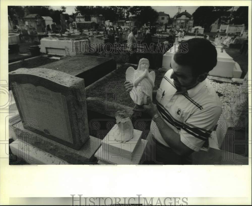 1994 Press Photo Tom Juhas tests the fit on his newly recovered angel - Historic Images