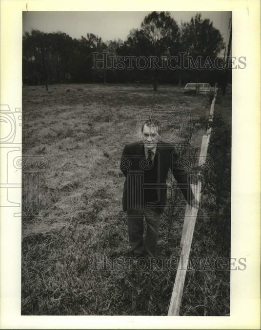 1988 Press Photo Developer G. K. Juno stands in the 14-acre tract for housing. - Historic Images