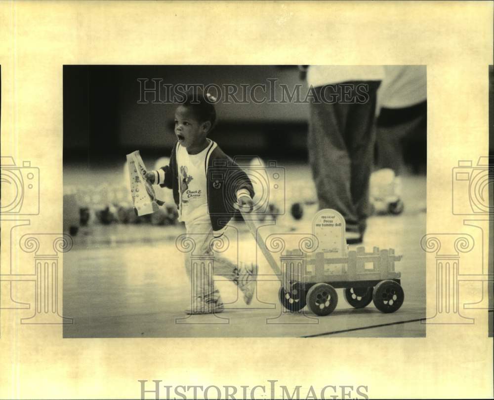 1994 Press Photo Candice Alexander with new toy wagon from the toy giveaway - Historic Images