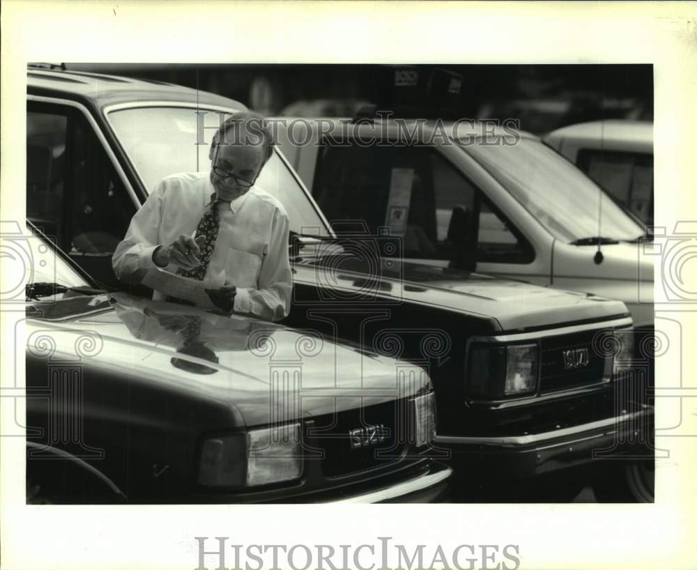 1992 Press Photo Sales Manager Don Hollowell goes over inventory at Benson Isuzu - Historic Images