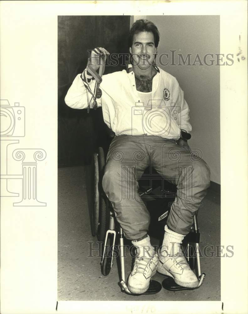 1988 Press Photo Doug Heir holding his metals from the 1984 Wheelchair Olympics. - Historic Images