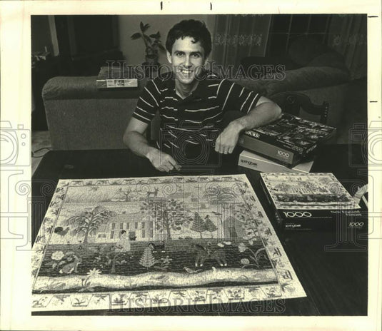 1987 Press Photo Jon Khachaturian at his home with jigsaw puzzles. - Historic Images