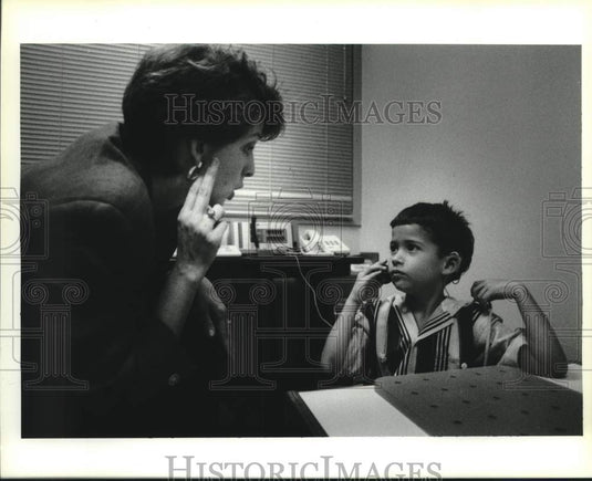 1994 Press Photo Tammy Crabtree signals to Rhett to test his new hearing implant - Historic Images