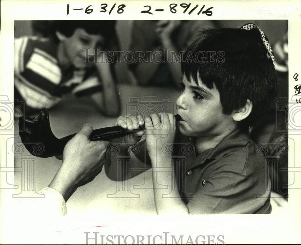 1987 Michael Rootman tries using Shofar at Lakeshore Hebrew School - Historic Images