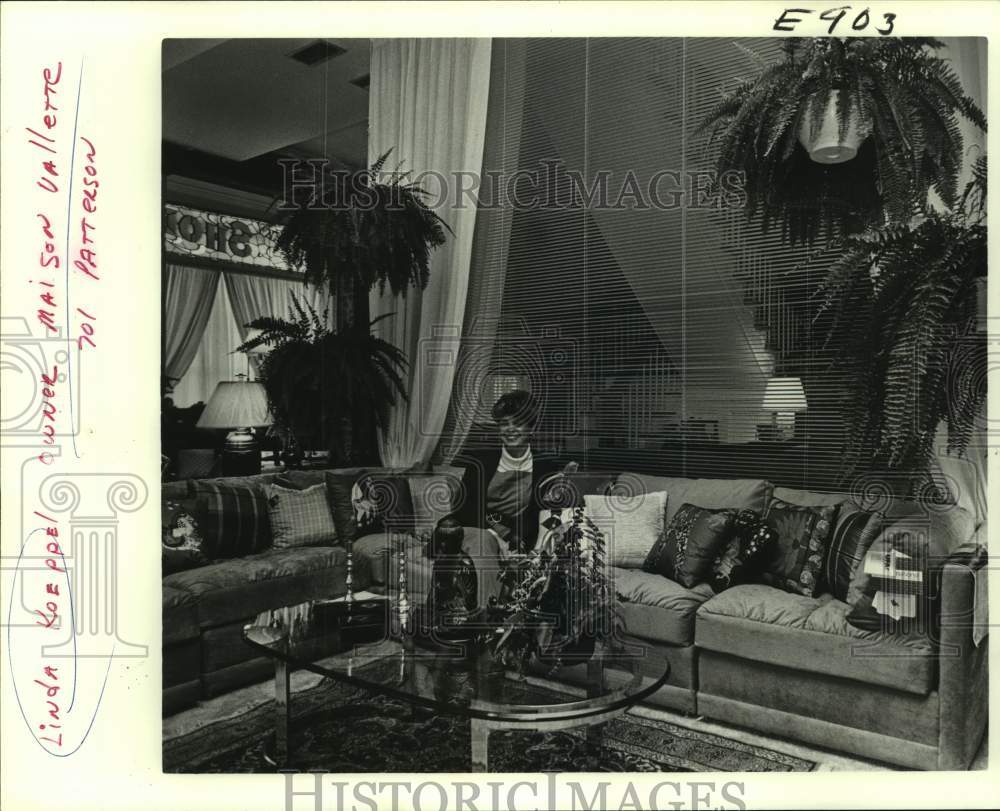 Press Photo Woman Seated On Sectional Sofa In Plant-Filled Great Room - Historic Images