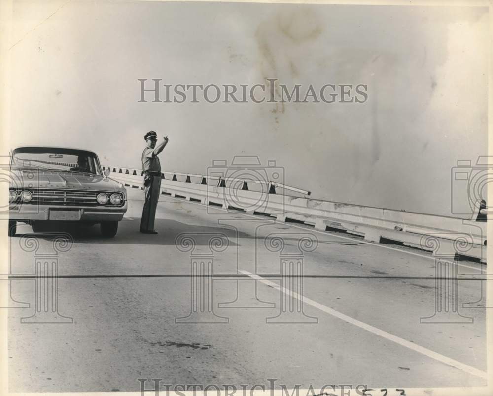 1964 Sgt. Petit Sr. directs traffic on Lake Pontchartrain Causeway-Historic Images