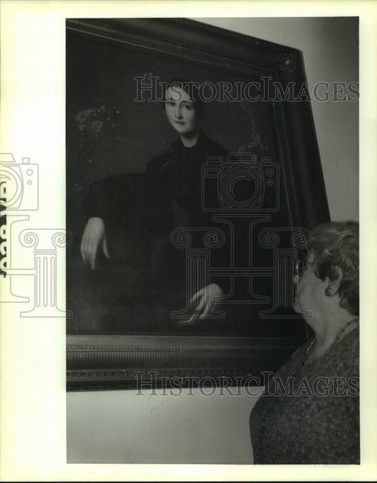 1992 Press Photo Anita Breisacher looks at a portrait of "The Lady in Black." - Historic Images