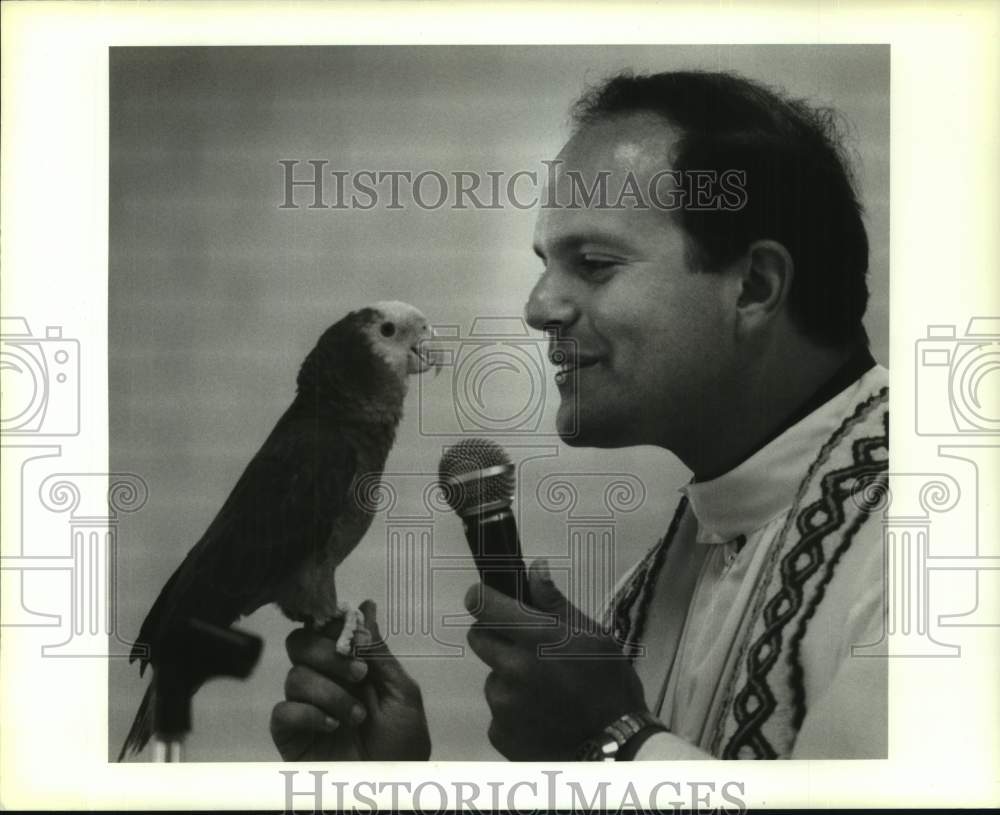 1991 Press Photo Father Jose Lavistada tries to get parrot, India to talk - Historic Images