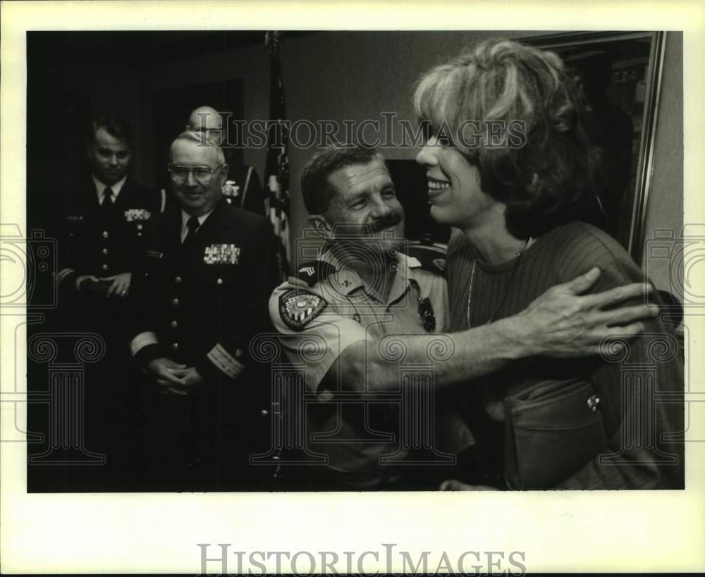 1996 Press Photo Causeway Police Sgt. James LeBlanc gets hug from wife Leslie - Historic Images