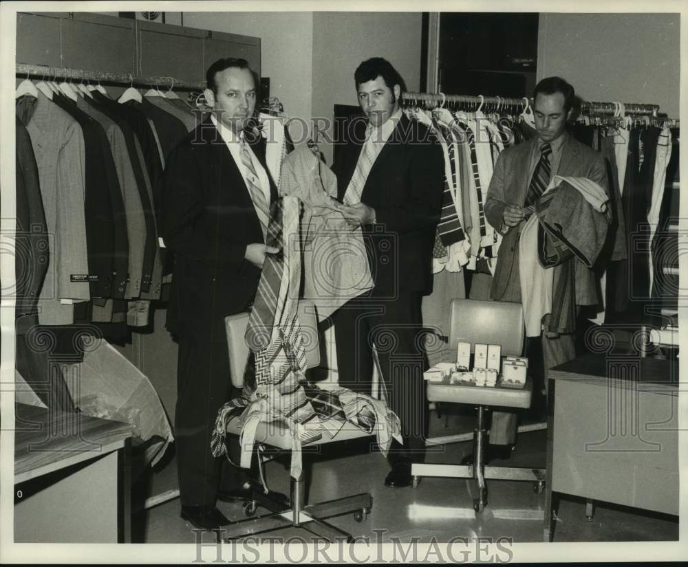 1971 Guy Le Blanc, Leslie Bonano and Craig Jenning examine clothes - Historic Images