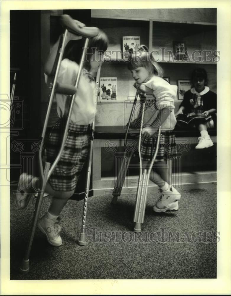 1995 Press Photo Students from St. Christopher school experience crutches. - Historic Images