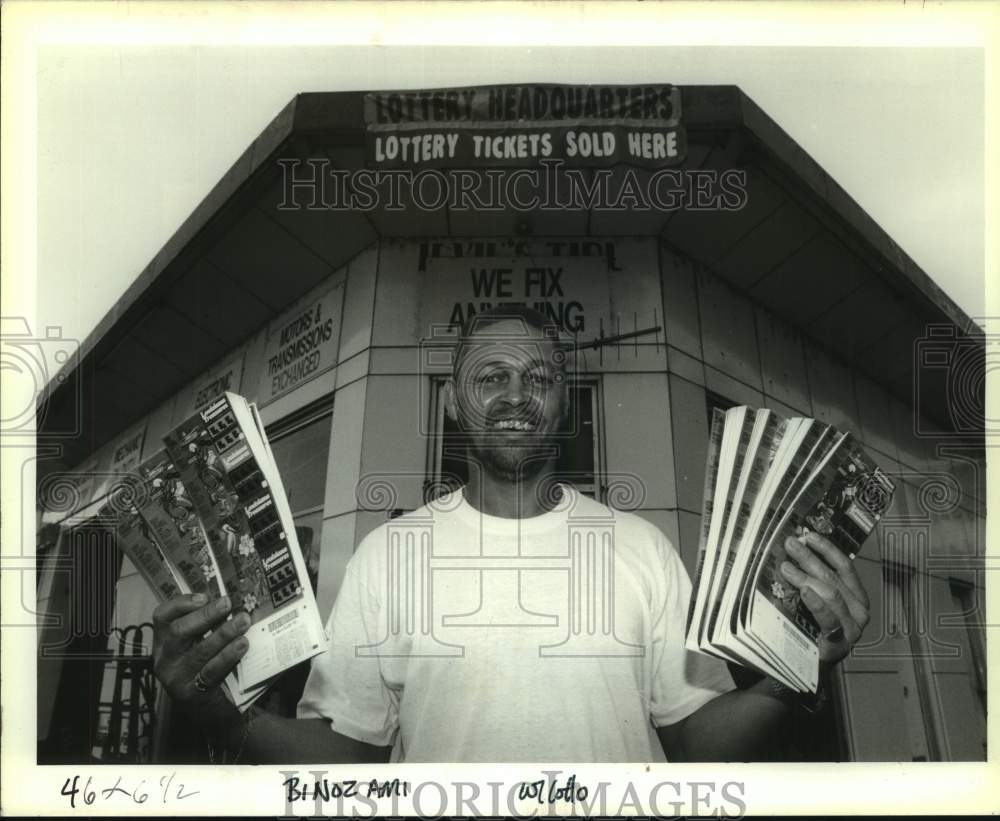 1991 Press Photo Adam Irvin sells lottery tickets at his Tire Service Shop - Historic Images