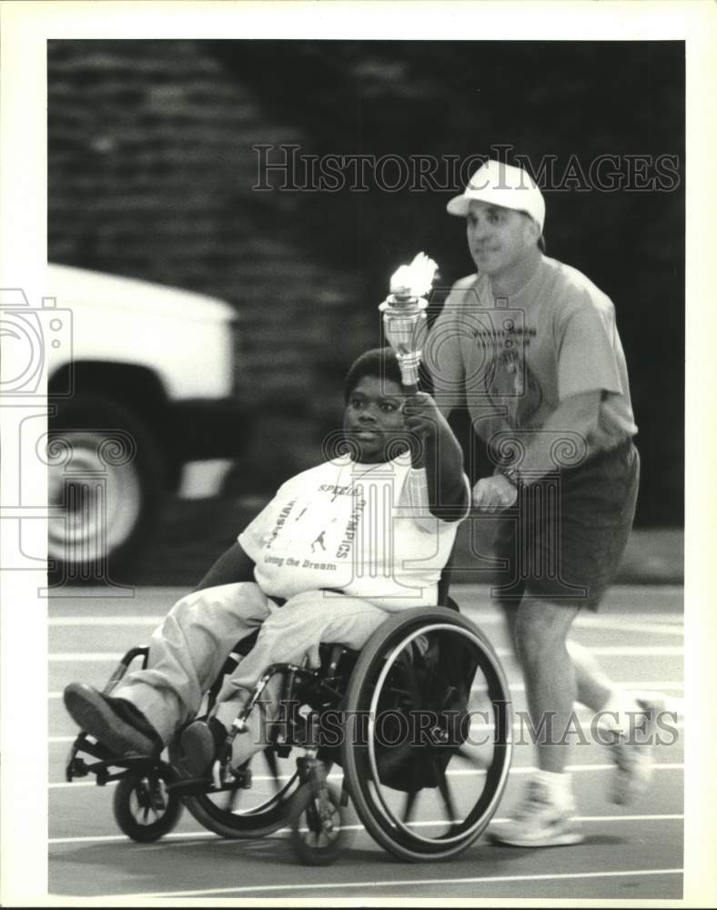 1994 Greg Maurin pushes Michael Chapman during Special Olympics Game - Historic Images