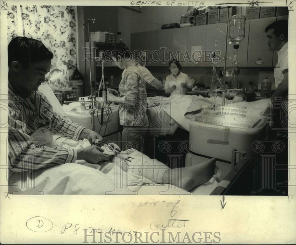1967 Bobby Cook during his dialysis, his wife Laura behind him - Historic Images