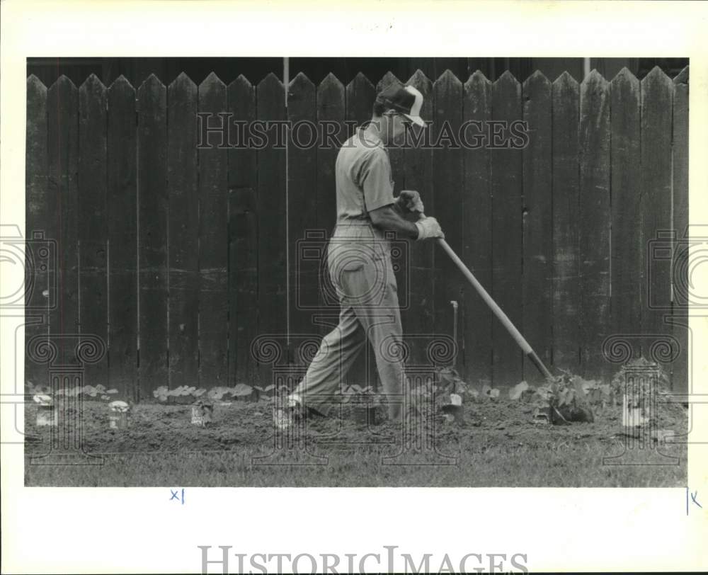 1989 Press Photo Raymond Labit strolls through his vegetable garden - Historic Images