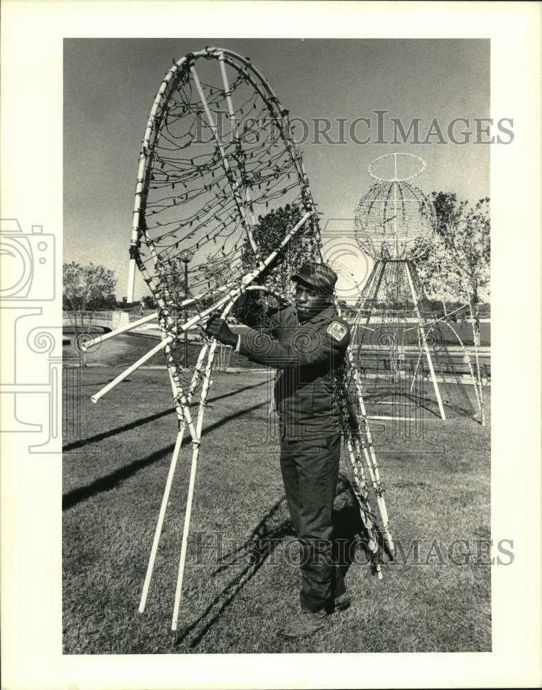 1988 Press Photo Augustus Page, carries angel wings to Lafreniere Park - Historic Images