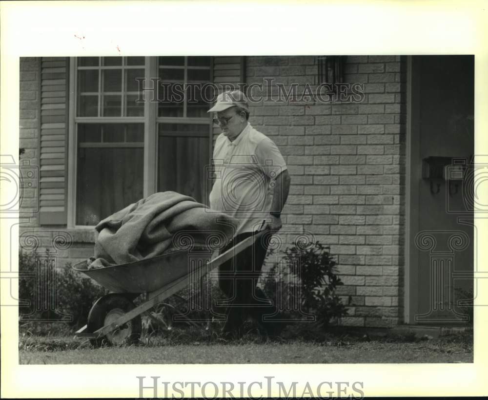 1989 Press Photo Walter Jones Removes Ruined Carpet During Flood Cleanup - Historic Images