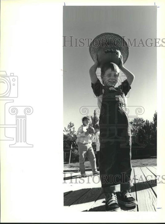 1989 Press Photo James Turner holds his decorated pumpkin at his school. - Historic Images