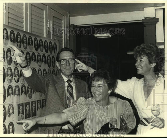 Press Photo Alumnus pointing to their picture during Newman Class of '43 reunion - Historic Images