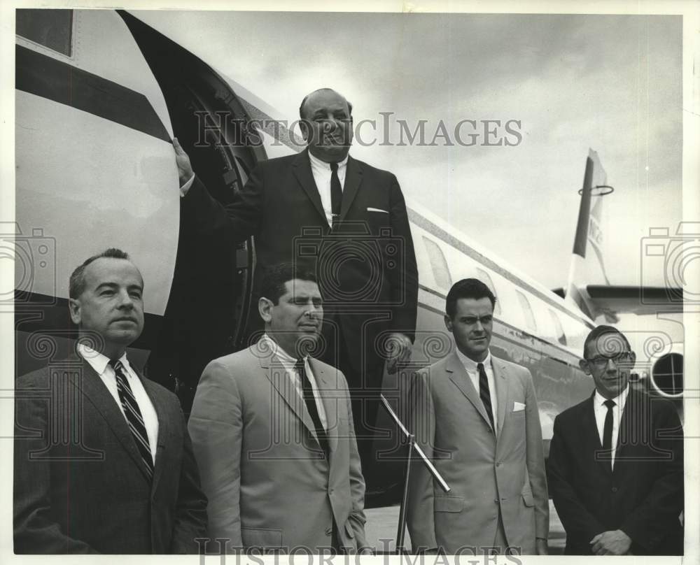 1965 New Orleans architect Mark Lowrey and officers get off a plane - Historic Images
