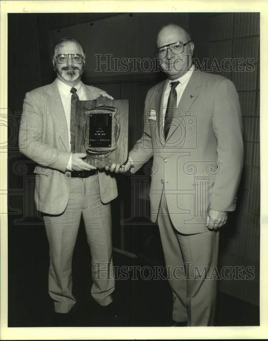 1988 Press Photo Wally Maitrejean honored by James M. Cain of L.P. & L. - Historic Images