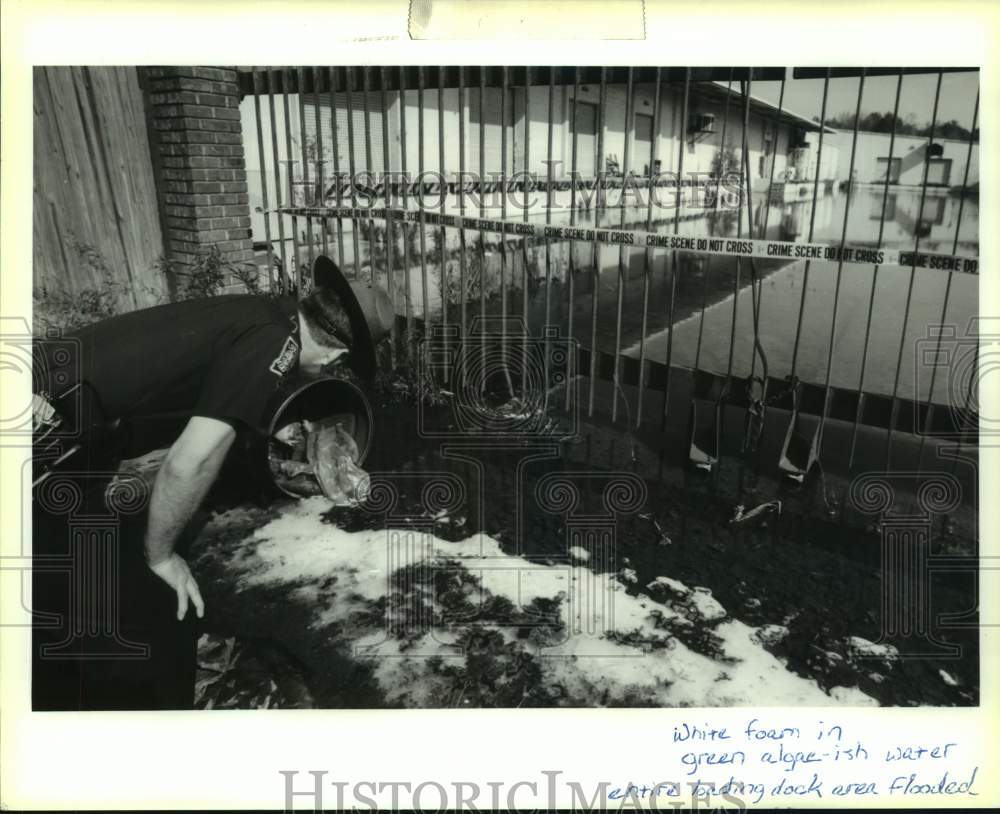 1991 Press Photo Lt. Kenny Williams checks discarded barrel at Malter Intl. - Historic Images