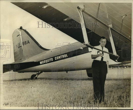 1967 Mosquito Control director George Carmichael checks spray plane-Historic Images