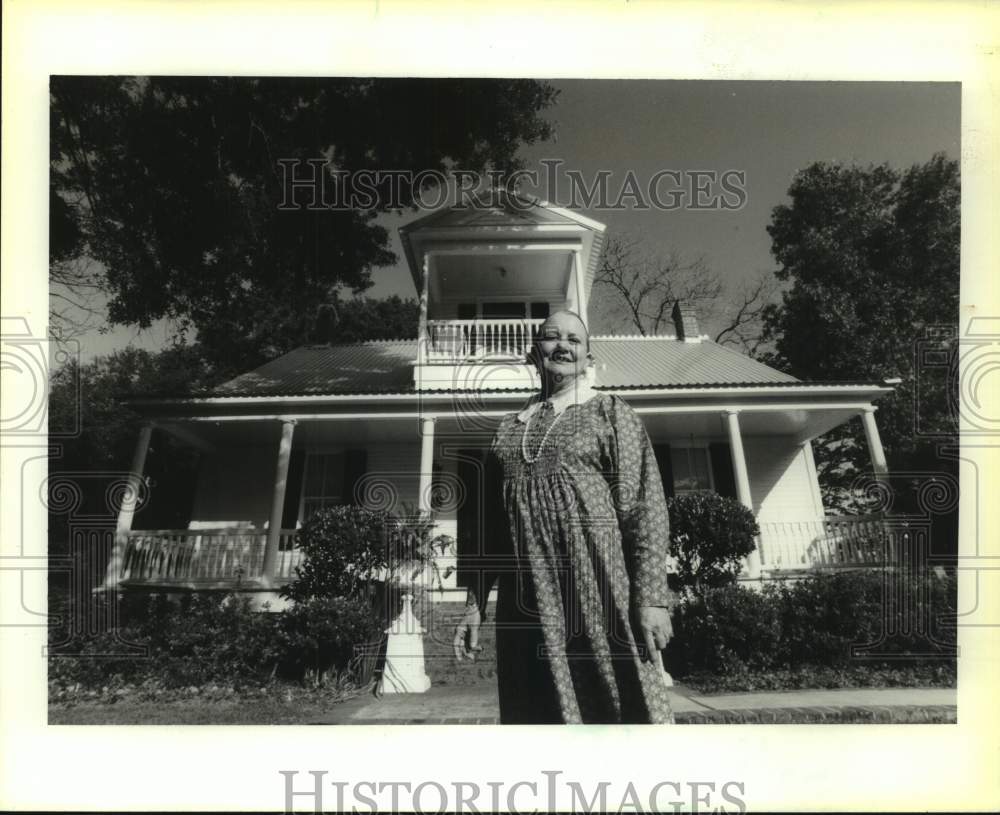 1992 A woman stands in front of her house in New Orleans - Historic Images