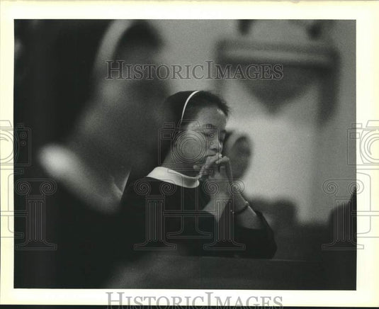 1989 Sister M. Martin Thienan prays during morning mass - Historic Images