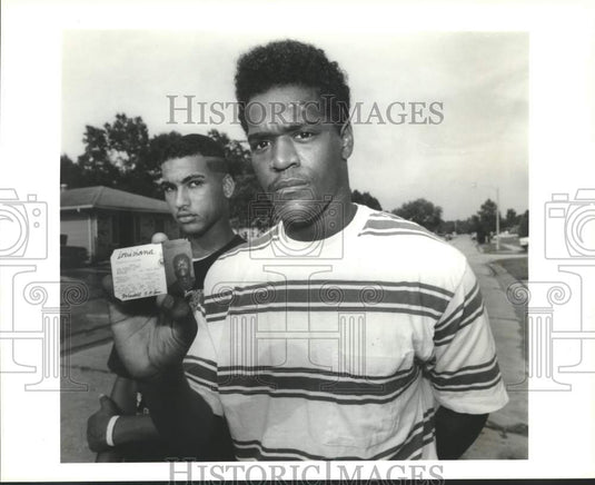 1991 Alvis Douglas with Wendell Sam holding altered driver's license - Historic Images