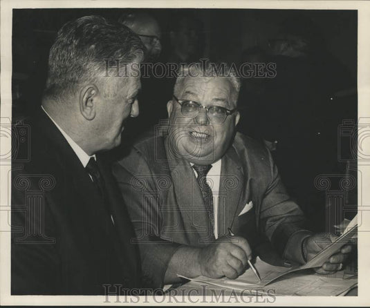 1965 Frank Zeller and Ewell St. Amant look over union contract. - Historic Images