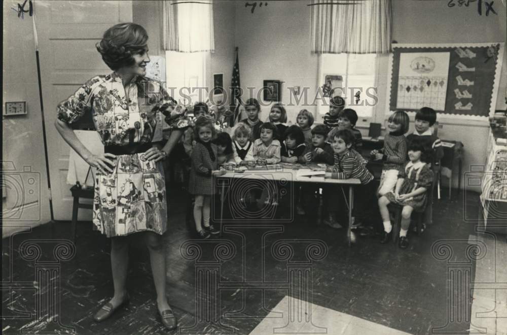 Mrs. Lind shows dress she sewed to St. Andrew Episcopal School kids - Historic Images