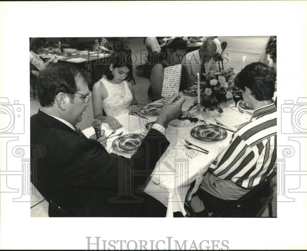 1995 Richard Kimball Holds Matzoh at Jewish Passover Seder Meal - Historic Images