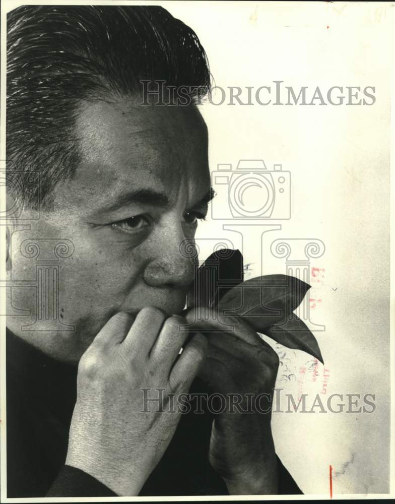 1979 Philippines Monsignor Domingo Nebres plays music on leaf - Historic Images