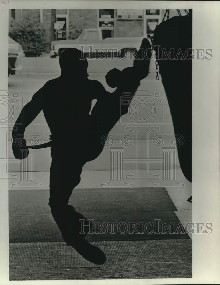 1988 Byron &quot;Black Cobra&quot; Robinson practices his kick boxing at gym - Historic Images